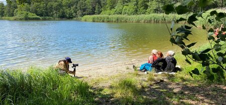 Dreh der dritten Folge unserer Webvideo-Reihe: Die Protagonstin Nura sitzt mit Freundinnen am See.