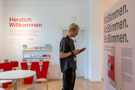 Besucher in der Ausstellung zur Landtagswahl in Brandenburg 2024