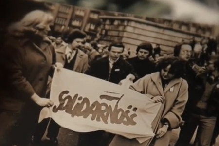 Schwarz-weiße Aufnahme einer Gruppe von Menschen, die ein Banner mit der Aufschrift 'Solidarność' halten.