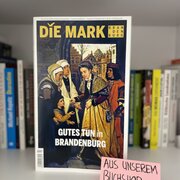 Im Hintergrund eine Reihe Bücher. Im Vordergrund die aktuelle Ausgabe der Zeitschrift "Die Mark Brandenburg".