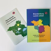 Das Bild zeigt die Hefte „Klima-Schutz in Brandenburg. Ein Text in Leichter Sprache“ und „Brandenburg Leicht erklärt. 4 Hefte in Leichter Sprache“.