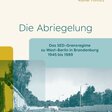 Ältere Frau schiebt Fahrrad im ehemaligen Grenzstreifen.